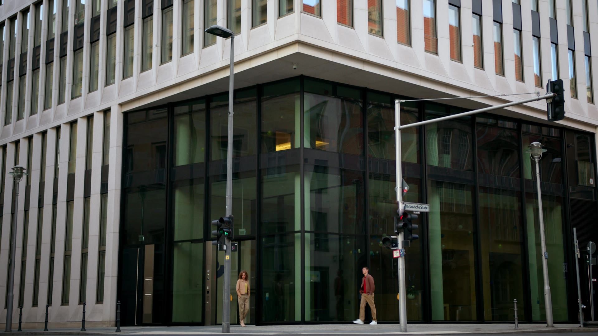 Still from the Milestone Spring Summer 25 campaign film: a man in front of a glass office building