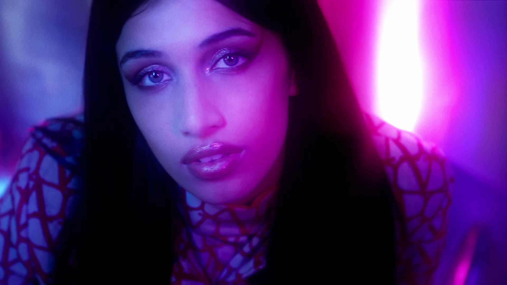 Still from the fashion film »disco« for Schön! magazine: a face lit in purple and blue